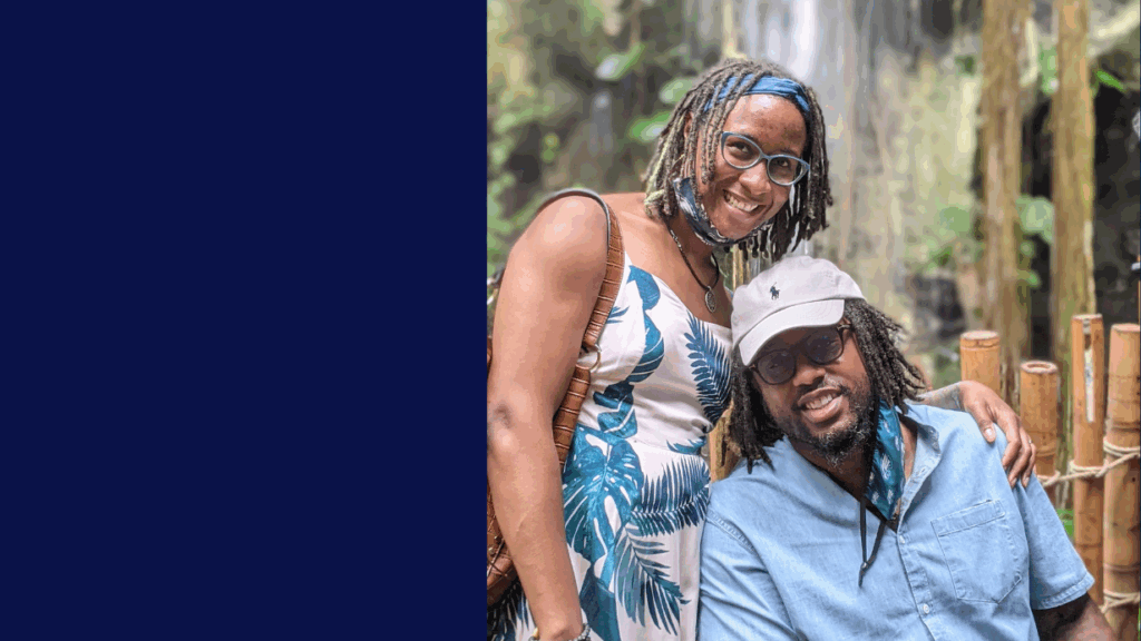 A smiling woman in a sleeveless dress stands next to a seated man in a blue shirt and light cap. Outdoors before bamboo railings and a blurred waterfall, they share a moment that could be part of Lionels Story, with blue hues on the image’s left side.