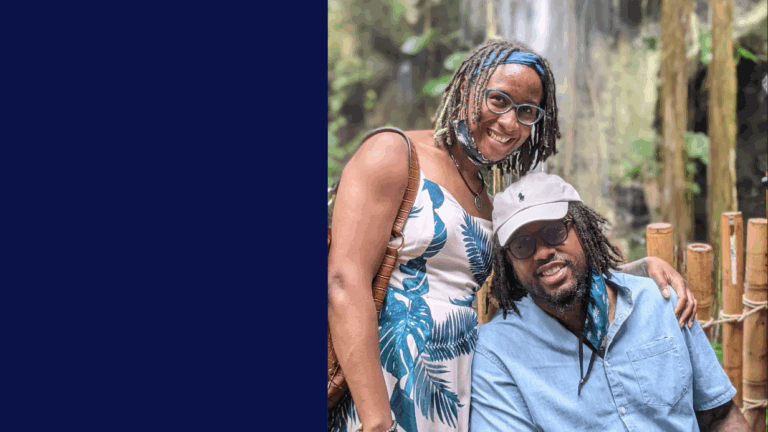 A smiling woman in a sleeveless dress stands next to a seated man in a blue shirt and light cap. Outdoors before bamboo railings and a blurred waterfall, they share a moment that could be part of Lionels Story, with blue hues on the image’s left side.