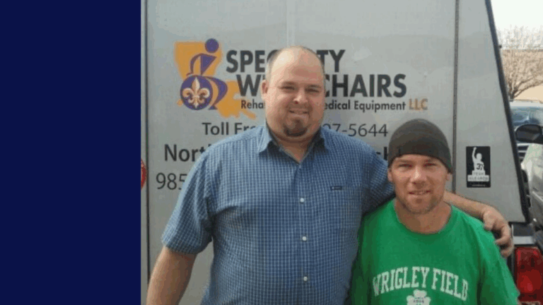 Two men stand in front of a van labeled Specialty Wheelchairs. The man on the left wears a blue plaid shirt, while the man on the right, featured in Jeffs Story, wears a green Wrigley Field T-shirt and a dark beanie.