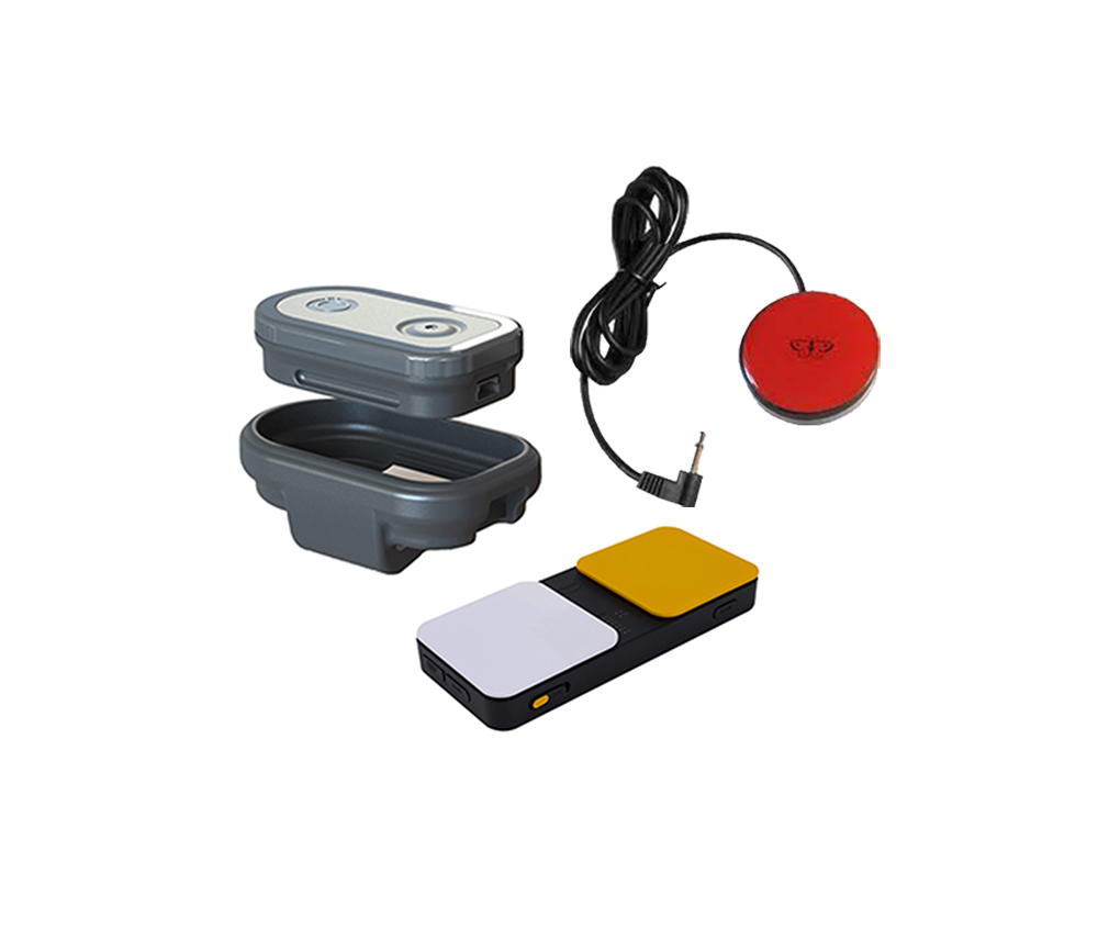A set of Speech Solutions devices, featuring a gray and white speech-generating device with open case, a black device with white and yellow buttons, and a red circular switch with a black cord powered by voice technology.
