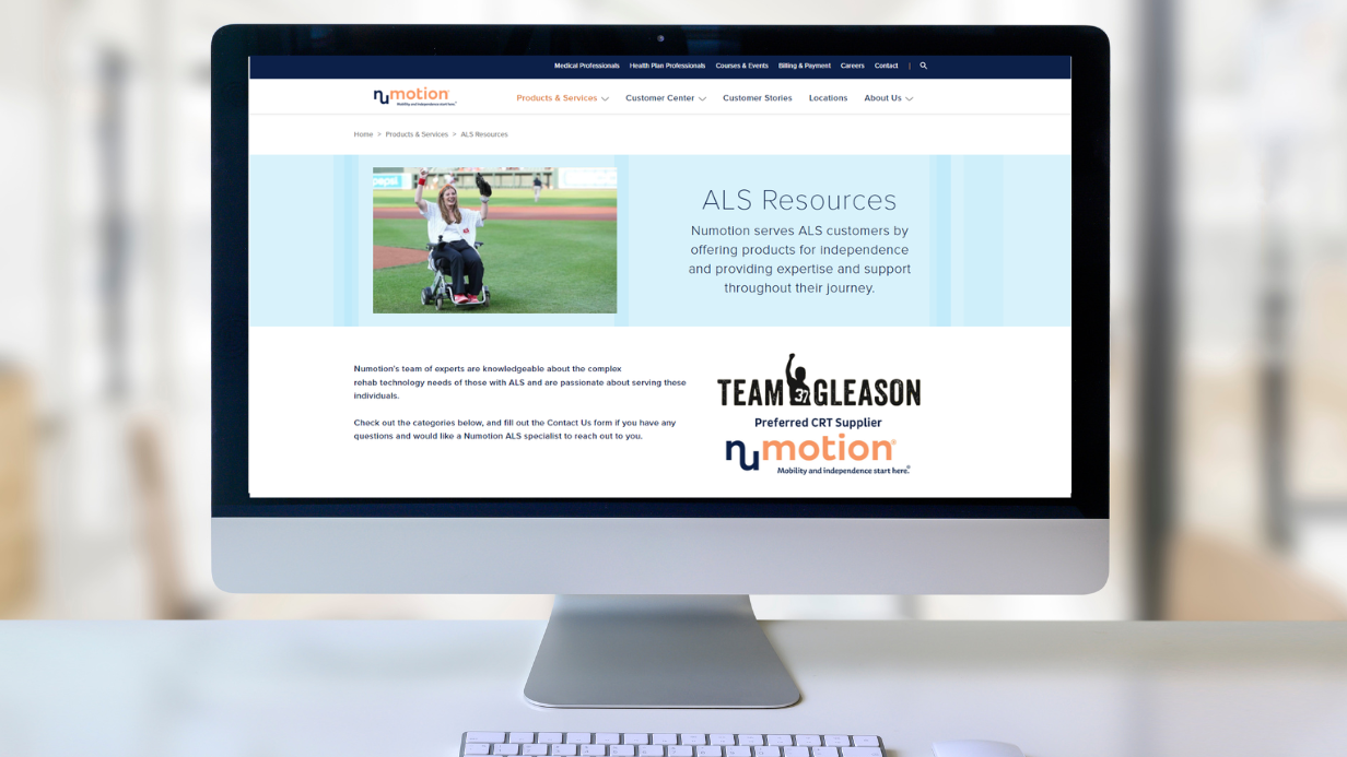 A computer monitor displays the Numotion ALS Resources page, featuring a woman in a wheelchair outdoors, text about empowering individuals with ALS, and partnership logos for Team Gleason and Numotion.