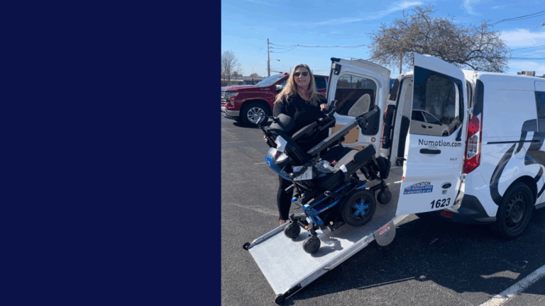 Cynthias Story: A woman stands on a van’s wheelchair ramp, holding a power wheelchair. The white van has an open rear door and “Numotion.com” on the side. The scene unfolds in a sunny parking lot.