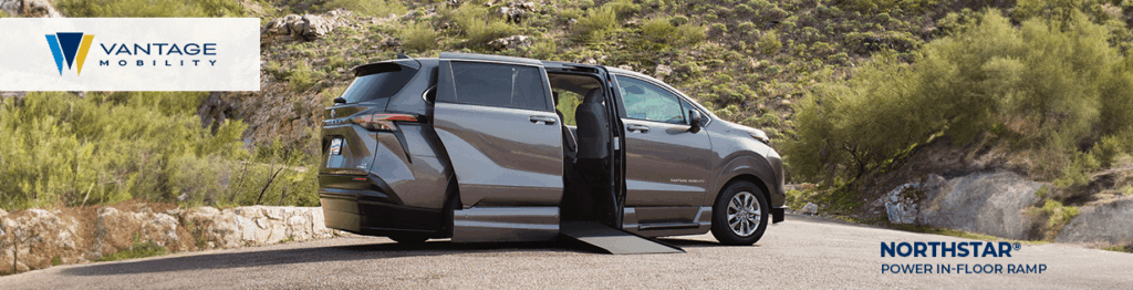 A silver minivan with a deployed power ramp is parked on a paved road surrounded by green hills. The Vantage Mobility logo is on the left, and the Northstar Power In-Floor Ramp logo is on the bottom right, highlighting Wheelchair Accessible Vehicles.
