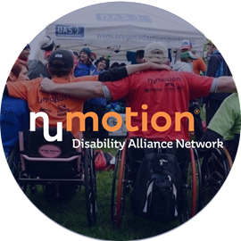 Two people in wheelchairs sit side by side with arms around each other at an outdoor event, surrounded by others. The text reads “numotion Disability Alliance Network,” highlighting the importance of Employee Resource Groups.
